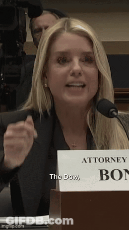 A Woman Speaking Into A Microphone With A Sign That Says Attorney Box GIF