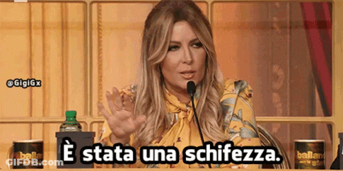 A Woman Speaking Into A Microphone With The Words E Stata Una Schiezza GIF