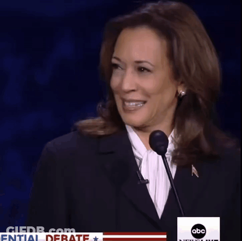 A Woman Speaking Into A Microphone With The Words Initial Debate On The Bottom GIF