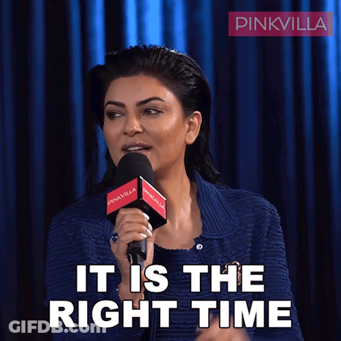 A Woman Speaking Into A Microphone With The Words It Is The Right Time Behind Her GIF