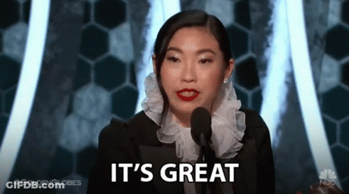 A Woman Speaking Into A Microphone With The Words It 'S Great Behind Her GIF