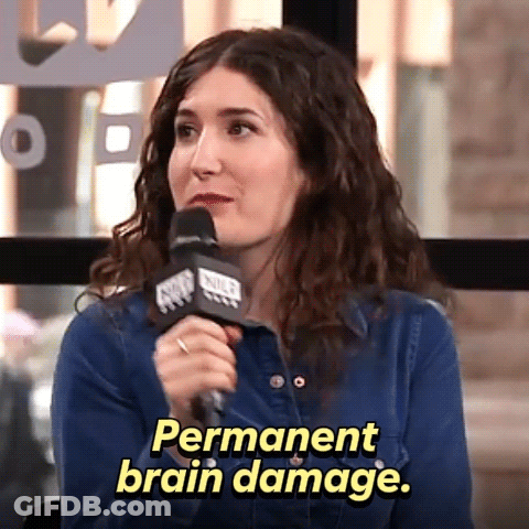 A Woman Speaking Into A Microphone With The Words Permanent Brain Damage Behind Her GIF