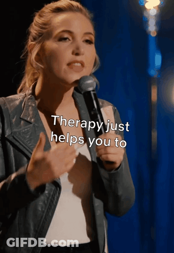 A Woman Speaking Into A Microphone With The Words " Therapy Just Helps You To " Above Her GIF