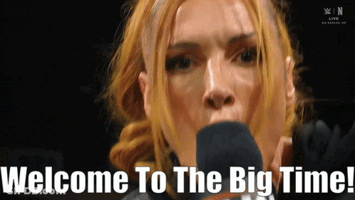 A Woman Speaking Into A Microphone With The Words Welcome To The Big Time Written Below Her GIF