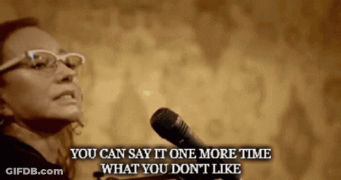 A Woman Speaking Into A Microphone With The Words " You Can Say It One More Time What You Don 'T Like " Below Her GIF