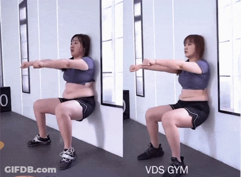A Woman Squatting Against A Wall With The Words Vds Gym On The Bottom Right GIF