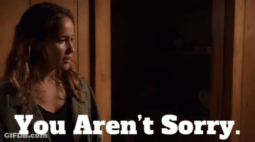 Woman Standing In Dark Room With You Aren't Sorry Text GIF