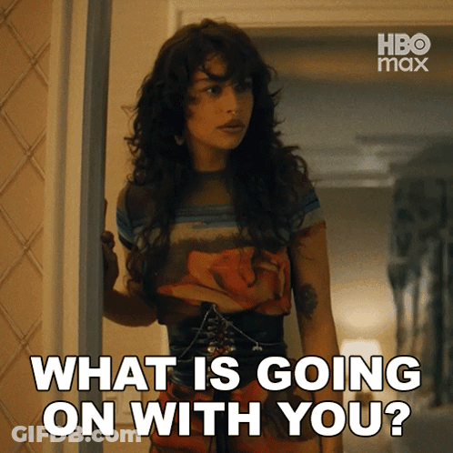 A Woman Standing In A Doorway With The Words " What Is Going On With You " Above Her GIF