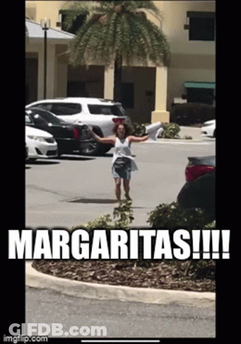 A Woman Standing In A Parking Lot With The Words Margaritas Written On It GIF