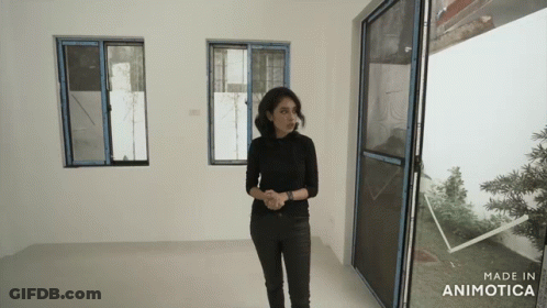 A Woman Standing In A Room With The Words Made In Animatica On The Bottom GIF