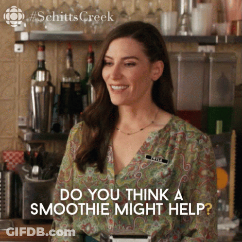 A Woman Standing In Front Of A Bar With The Words Do You Think A Smoothie Might Help Below Her GIF