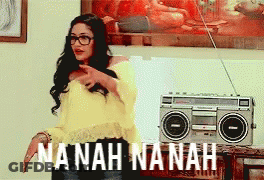 A Woman Standing In Front Of A Boombox That Says Nanah Nanah On It GIF