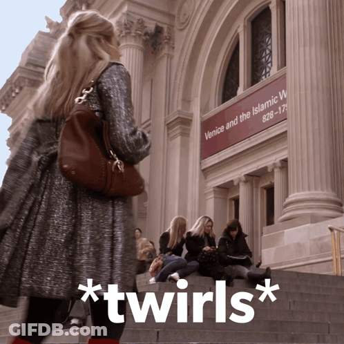 A Woman Standing In Front Of A Building That Says Venice And The Islamic World On It GIF