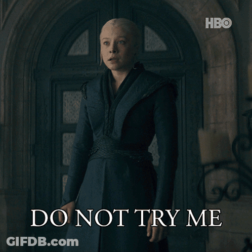 A Woman Standing In Front Of A Door With The Words Do Not Try Me On The Bottom GIF