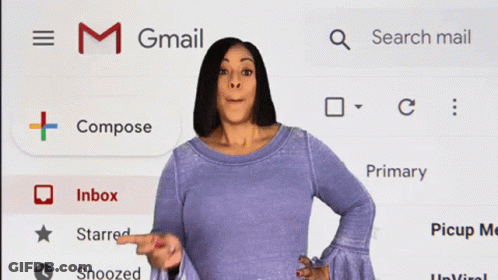 A Woman Standing In Front Of A Gmail Screen GIF