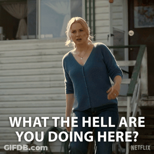 A Woman Standing In Front Of A House With The Words " What The Hell Are You Doing Here " Above Her GIF