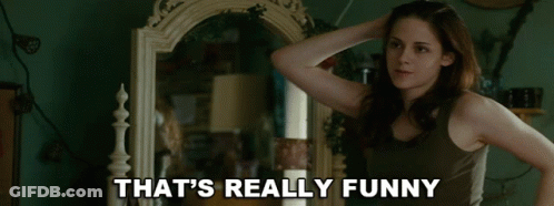 A Woman Standing In Front Of A Mirror With The Words That 'S Really Funny Written Below Her GIF