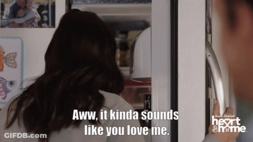 A Woman Standing In Front Of A Refrigerator With A Caption That Says Aww It Kinda Sounds Like You Love Me GIF