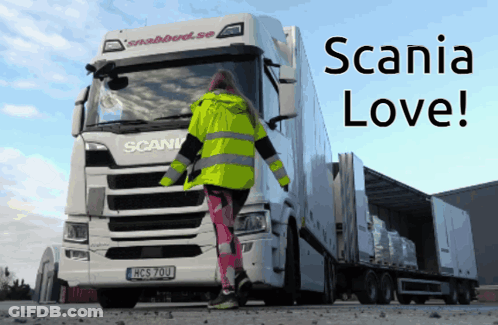 A Woman Standing In Front Of A Scania Truck That Says Scania Love GIF