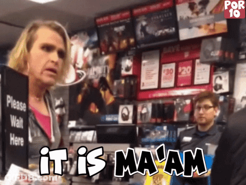 A Woman Standing In Front Of A Sign That Says It Is Ma Am GIF