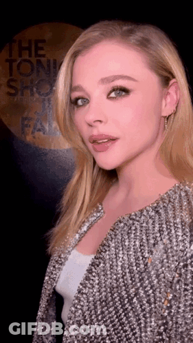 A Woman Standing In Front Of A Sign That Says The Tonight Show Fail GIF