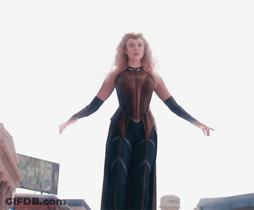 A Woman Standing In Front Of A Water Tower That Says Wet On It GIF