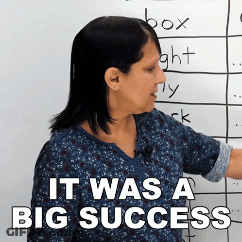 A Woman Standing In Front Of A White Board With The Words It Was A Big Success GIF