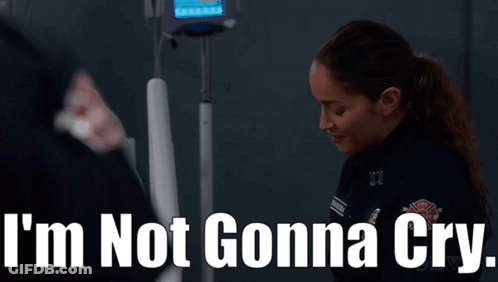 A Woman Standing In Front Of An Iv Machine With The Words I 'M Not Gonna Cry Written Above Her GIF