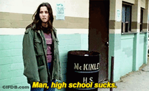 A Woman Standing Next To A Barrel That Says Mckinle Hs On It GIF