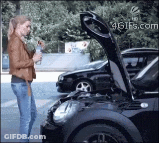A Woman Standing Next To A Black Car With The Hood Up GIF