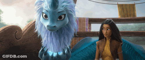 A Woman Standing Next To A Blue Dragon With A Unicorn Horn GIF