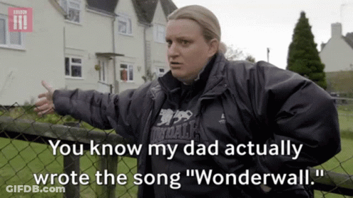 A Woman Standing Next To A Fence With The Words " You Know My Dad Actually Wrote The Song Wonderwall " GIF