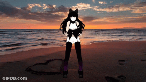 A Woman Standing On A Beach With A Heart In The Sand GIF