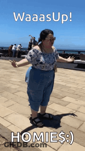 A Woman Standing On A Sidewalk With The Words Waasup Homies GIF
