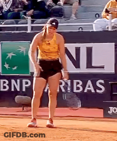 A Woman Standing On A Tennis Court In Front Of A Bnp Paribas Sign GIF