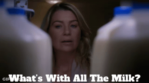 A Woman Stands Between Two Bottles Of Milk And Says What 'S With All The Milk ? GIF