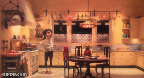 A Woman Stands In A Kitchen Holding A Bowl GIF