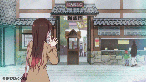 A Woman Stands In Front Of A Building With A Sign That Says " Entrance " GIF