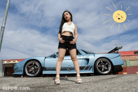 A Woman Stands In Front Of A Car That Says Walker GIF