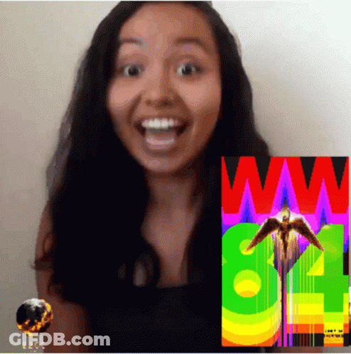 A Woman Stands In Front Of A Colorful Poster That Says Ww GIF
