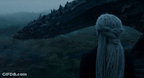 A Woman Stands In Front Of A Large Black Dragon With The Words Calm Below Her GIF