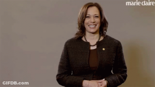 A Woman Stands In Front Of A Marie Claire Ad GIF