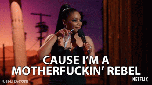 A Woman Stands In Front Of A Microphone And Says " Cause I 'M A Motherfucking Rebel " GIF