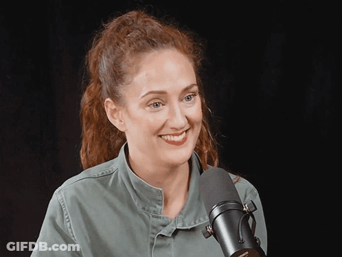 A Woman Stands In Front Of A Microphone That Says Shure GIF