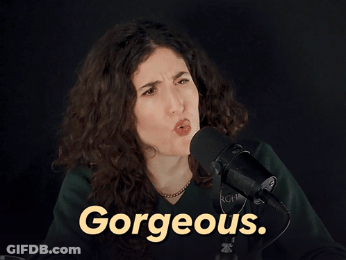 A Woman Stands In Front Of A Microphone With The Word Gorgeous In Yellow GIF