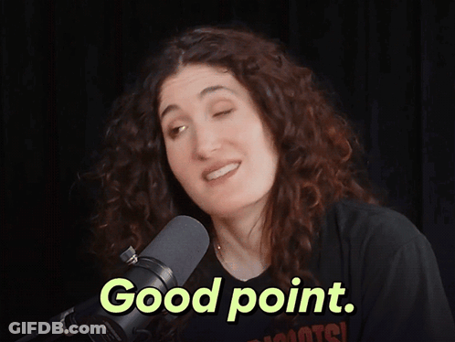 A Woman Stands In Front Of A Microphone With The Words Good Point Above Her GIF
