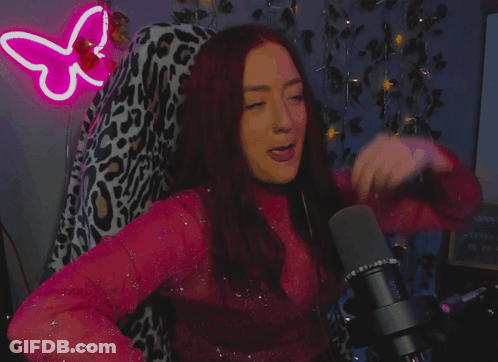 A Woman Stands In Front Of A Microphone With The Words " Mic Drop " On The Bottom GIF