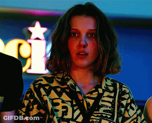 A Woman Stands In Front Of A Neon Sign That Says I GIF