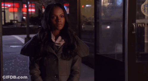 A Woman Stands In Front Of A Phone Booth That Has The Word Pull On It GIF