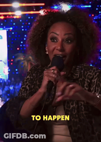 A Woman Stands In Front Of A Red Bull Sign GIF